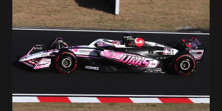 2025 Haas VF-25. Photograph by Liauzh, CC BY-SA 4.0. https://commons.wikimedia.org/wiki/File:2025_Japan_GP_-_Haas_-_Esteban_Ocon_-_FP2.jpg Fit to 2:1 with dark side borders.